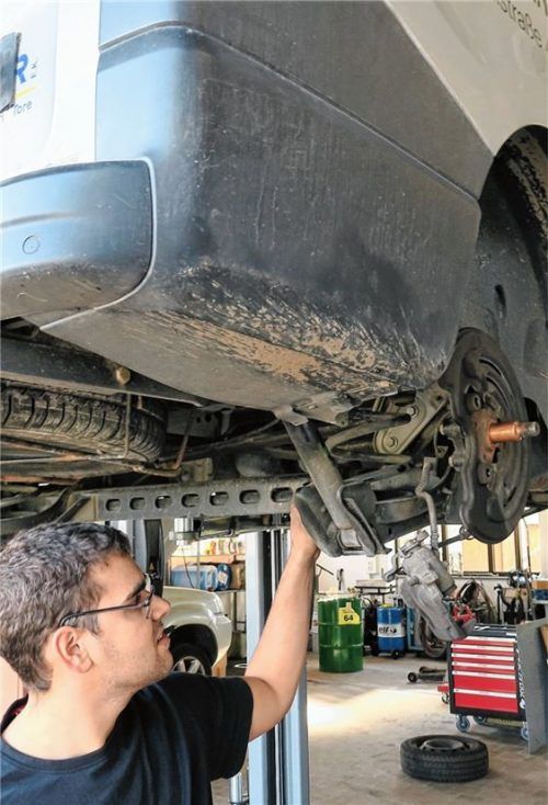 Kfz-Mechatroniker Markus Eichner prüft die Bremsen des Fahrzeugs.