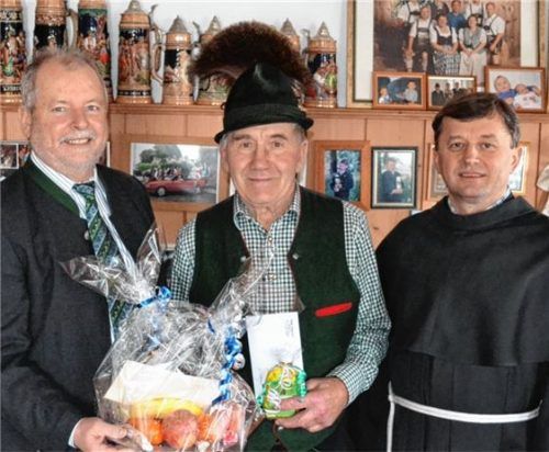 Gratulation für den Jubilar: Bürgermeister Sebastian Forstner (links) überreicht Heinrich Thusbaß im Beisein von Pater Christop einen Präsentkorb.Foto niessen