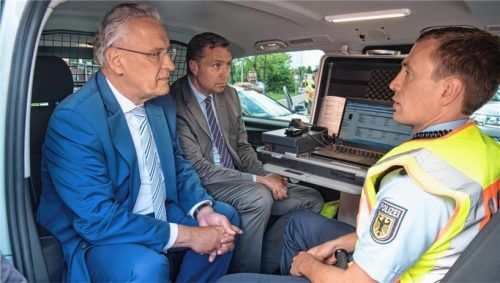 Anschauungsunterricht: Bayerns Innenminister Joachim Herrmann (links) und Stephan Mayer, Staatssekretär im Bundesinnenministerium, inspizieren mit Polizeihauptmeister Torben Wendt bei Kiefersfelden eine mobile Kontrollstation. Foto dpa