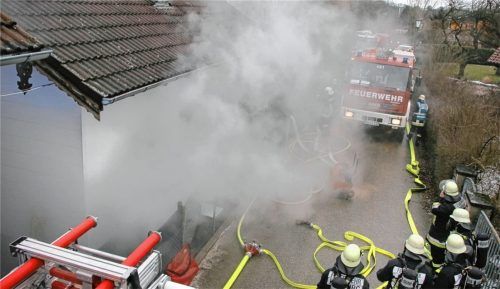 Dichter Rauch behindert die Arbeit der Feuerwehr. Bei dem Zimmerbrand am Samstagnachmittag in der Bruckhäuslnstraße in Kraiburg, bei der der Bewohner verstarb, kamen Atemschutzgeräteträger zum Einsatz. Ein Überdrucklüfter blies den beißenden Rauch aus den Räumen.Foto fib