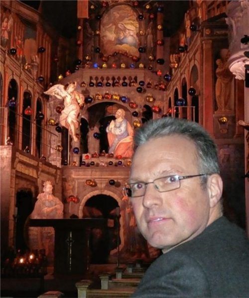 Pfarrer Paul Janßen. Im Hintergrund die bereits aufgebaute Kulisse zum Heiligen Grab in der Aschauer Pfarrkirche. Foto re