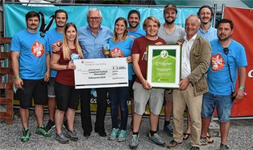 Die Freude über den symbolischen Scheck aus den Händen von WV-Vorsitzendem Reinhold Frey (hinter Scheck, Mitte) war groß: Landkreis-Kulturreferent Christoph Maier-Gehring (Dritter von rechts) überreicht stellvertretend die Urkunde an Xaver Mayerl vom Verein Luegstock. Foto Schlecker