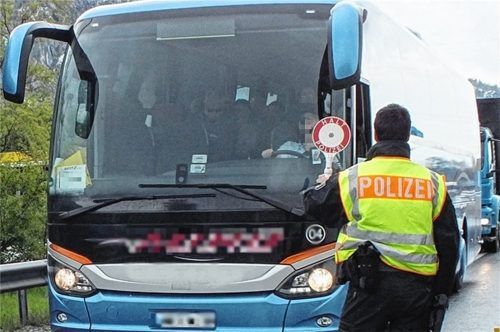 Ein Bundespolizist stoppt an der Grenze bei Kiefersfelden einen Bus, um die Insassen zu kontrollieren. Fotos BundesPolizei