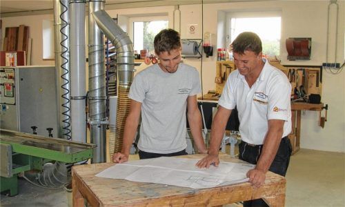 Ausbildung und das Thema Nachhaltigkeit sind ihm wichtig: Rosenheims neuer Zimmerer-Obermeister Thomas Pichler (rechts), hier in seiner Werkstatt in Raubling, mit Mitarbeiter Lucas Zaisserer. Foto re
