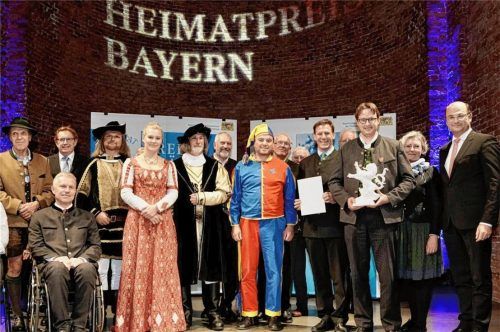 Hocherfreut nahm die Delegation des Volkstheaters Ritterschauspiele Kiefersfelden den Heimatpreis Bayern entgegen. Eingerahmt von Finanz- und Heimatminister Albert Füracker, ganz rechts neben Theatervorsitzendem Philipp Kurz und Kiefersfeldens Bürgermeister Hajo Gruber, ganz links. Dahinter Dieter Kannengießer, stellvertretender Rosenheimer Landrat. Foto Christian Blaschka