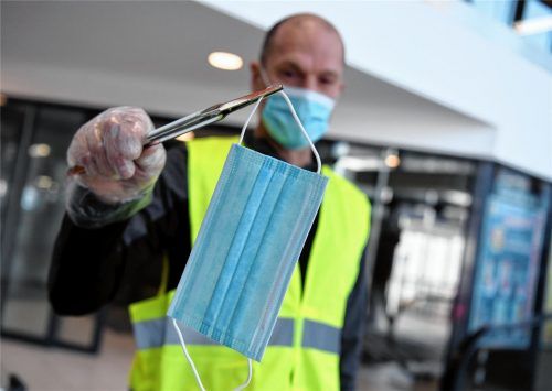 Ein Mitarbeiter eines Supermarktes verteilt Schutzmasken. Das Tragen von Mundschutz ist in Österreich bereits seit dem 6. April in Supermärkten ab einer Verkaufsfläche von 400 Quadratmetern verpflichtend. Unsere Leser beschäftigt das Thema ebenfalls seit Wochen. Foto dpa