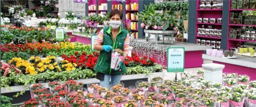 Handschuhe und Mundschutz tragen die Mitarbeiter des Gartencenters, wie die Angestellte Manuela Eder. Fotos Riediger