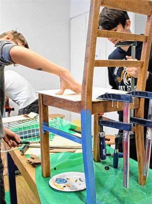 Voller Einsatz: Schüler der Wasserburger Mittelschule kreieren aus alten Stühlen und Abfall farbenfrohe Kunstwerke.