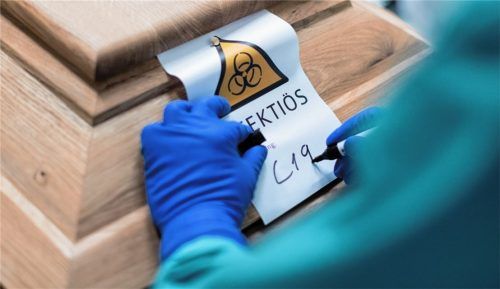 Mit Schutzausrüstung am Sarg: Strenge Hygienevorschriften zum Schutz vor Infektionen sind ein täglicher Begleiter für die Rosenheimer Bestattungsunternehmen. Foto DPA