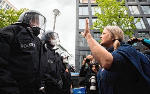 Eine Demonstrantin im Gespräch mit Polizisten: Nicht immer sind die Proteste gegen die Corona-Maßnahmen in den letzten Wochen so friedlich abgelaufen. Foto dpa
