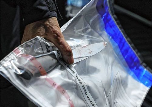Ein Kriminaltechniker stellt ein Messer am Tatort sicher. In Raubling verletzte eine 24-Jährige einen 54-jährigen Fernfahrer mit einem Stich. Dieser verursachte eine etwa zwölf Zentimeter auseinanderklaffende, stark blutende Schnittwunde am Hals.Foto dpa