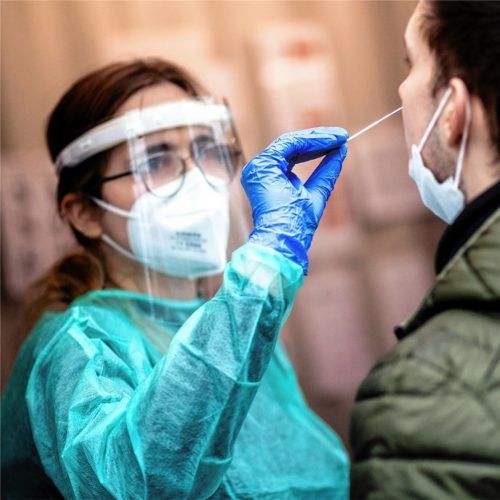 Eine Mitarbeiterin einer Teststation führt einen Corona-Test an einem jungen Mann durch. In der Debatte um mögliche Lockerungen von Corona-Maßnahmen in Deutschland raten Fachleute zur Vorsicht, während manche Bürger schon ungeduldig auf das Ende aller Beschränkungen warten. Foto dpa