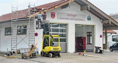 Atzinger Feuerwehrleute reparieren den Gebäudeschaden, der von einem bislang unbekannten Lkw-Fahrer verursacht wurde.