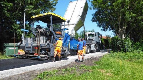 Mitarbeiter der Firma Grossmann, beauftragt durch die Stadt Kolbermoor, arbeiten an der Asphaltierung der Schlarbhofener Straße. Foto Riediger