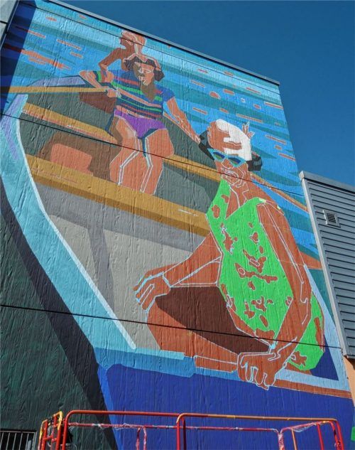 An einer Seitenwand des Modeparks Röther prangt das Werk von Stephan Hohenthanner – eine knallig-bunte Ruder-Szene.Foto Friedrich