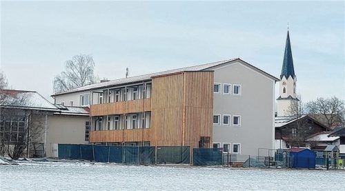 Sehr viel Geld hat die Gemeinde in die Hand genommen, um aus dem alten Schulhaus in Waldhausen das neue Kinderhaus für Kindergarten und Kinderkrippe zu machen. Hervorzuheben ist hierbei, dass für die Einrichtung von fünf KiGa-Gruppen keine weiteren Flächen versiegelt wurden. Auf dem Foto ist die Südostansicht mit der neuen eingehausten Notausgangstreppe und mit den neuen Fluchtbalkonen auf der Südseite zu sehen. Die AWO hat die Trägerschaft für das komplette Kinderhaus übernommen.
