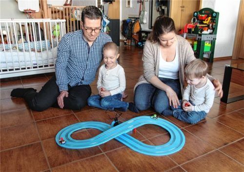 Voller Freude beim Spielen mit der Rennbahn: Maxi (links) und sein Bruder Moritz mit den Eltern Florian und Maria Schmidt.Foto Hadersbeck