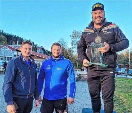 Die beiden Späth-Brüder (links) übergeben den Siegerpokal an Peter Rottmoser vom SV Schechen.Foto Albert Kamhuber