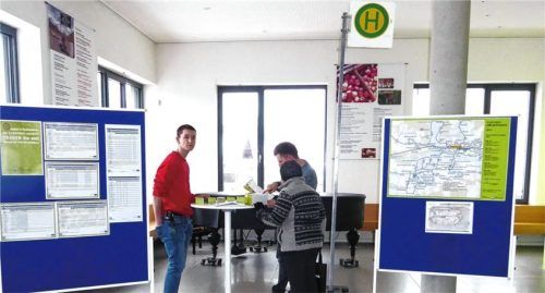 Die neue Haltestelle im Rathaus: Maximilian Müller (rechts) und Florian Kuhmann (links) vom Stadtbus-Team erklären einer Kolbermoorerin den neuen Fahrplan. Foto  Riediger