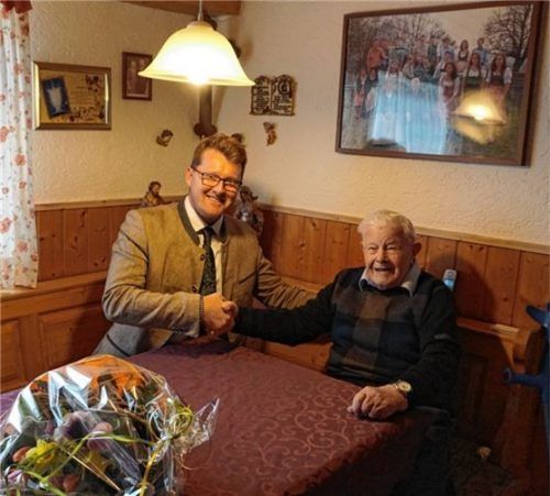 Bürgermeister Roland Kamhuber (links) gratulierte Simon Schmid zum Geburtstag mit Blumen und der Gemeindemedaille in Bronze.Foto sutherland