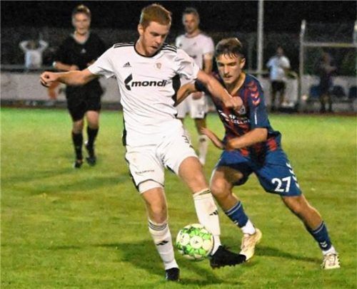 Der TuS Raubling und der TSV Dorfen trennten sich unter Flutlicht 2:2. Raublings Dominic Reisner (links, gegen Bastian Rachl) holte einen Elfer heraus.Foto Franz Ruprecht