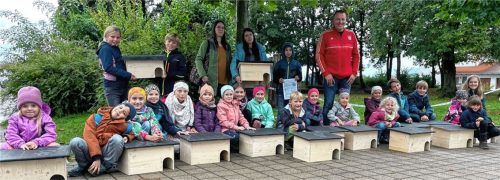 Stolz präsentieren die Kinder ihre selbst gebauten Igelhäuschen. Foto re