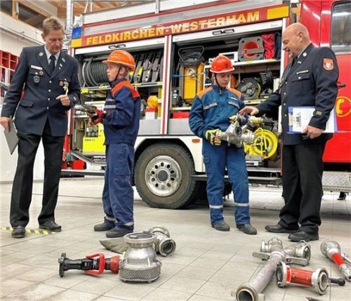 Unter den Blicken von Bereichsjugendwart Andreas Pöcher (links) und Kreisbrandmeister Werner Maier-Matheke ordneten Kilian (Zweiter von links) und Julian (Zweiter von rechts) die wasserführenden Armaturen in Rubriken ein.