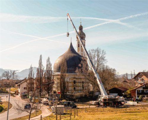 Ein Spezialkran mit 75 Meter langem Ausleger hob jetzt das Kreuz samt Zeitkapsel auf die Spitze der Westerndorfer Zwiebelkuppel. Fotos Aerzbäck