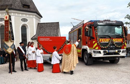 Pfarrer Ernst Kögler spendete den geistlichen Segen für das Löschgruppenfahrzeug „LF20KatS“ (rechts) und „Unwetteranhänger“ (links). Foto Strim