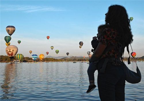 Eine Mutter und ihr Kind beobachten aufsteigende Heißluftballons. Pläne in der aktuellen Rentendiskussion könnten Frauen deutlich benachteiligen. Foto dpa