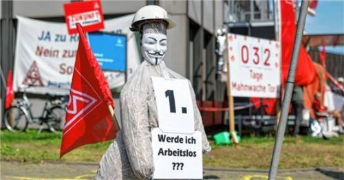Die Puppe eines symbolischen Stahlarbeiters trägt ein Schild mit der Aufschrift „Werde ich Arbeitslos???“ Foto dpa