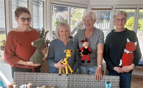 Vier Frauen aus der Soyener Strickgruppe präsentieren ihre handgemachten Stofftiere wie Hund, Giraffe, Marienkäfer und Katze.