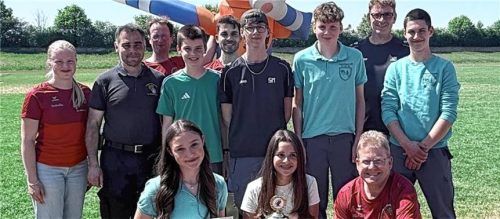 Das Foto „Siegerfoto Kreisentscheid 2026“ zeigt den neuen Kreismeister Au a. Inn mit (hintere Reihe stehend von links) Kreisjugendgruppensprecherin Isabella Rottner, Kreisbrandrat Julian Liebermann, stellvertretender Kreisjugendwart Markus Lippacher, Wettbewerbsleiter Andreas Linner sowie (erste Reihe rechts kniend) Kreisjugendwart Michael Matschi. Foto Matschi