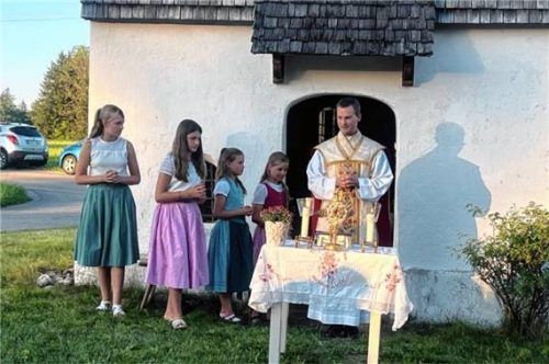 Pfarrer Philipp Werner zelebriert den Gottesdienst vor der Anna-Kapelle, assistiert von vier Ministrantinnen.