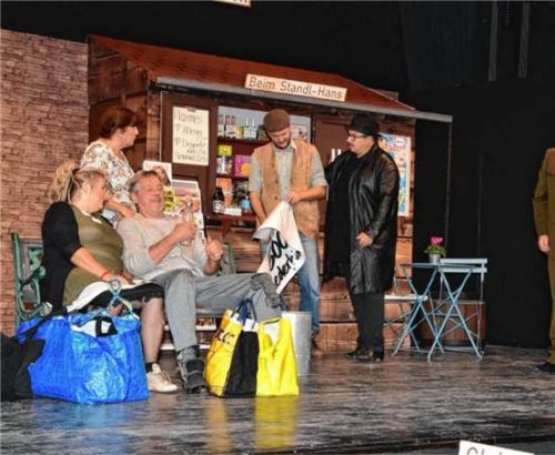 Das Ensemble der Theatergruppe Stephanskirchen auf der Bühne vor der Kulisse des Bahnhofskiosks. Schlecker