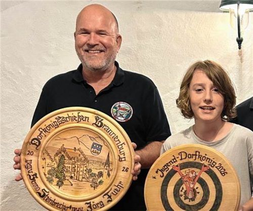 Stolz präsentieren die neuen Dorfkönige ihre Scheiben: Schützenkönig Jörg Fuehr (von links) und Jugendkönig Noah Nicko. U. Reitzig